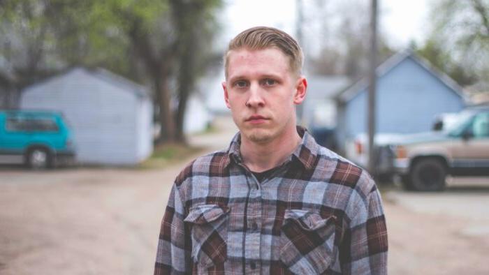 An outdoor headshot of a person.